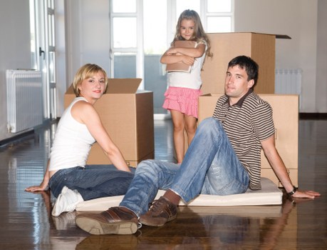 Packed office furniture and labeled boxes ready for move in Fulwell